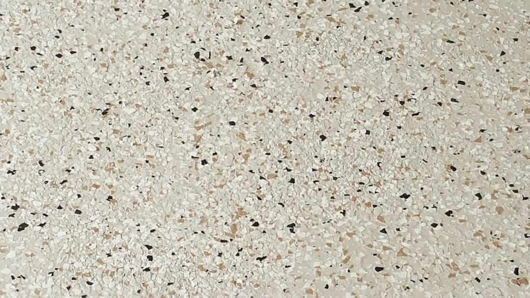Close-up of textured light terrazzo flooring with various small stone chips.
