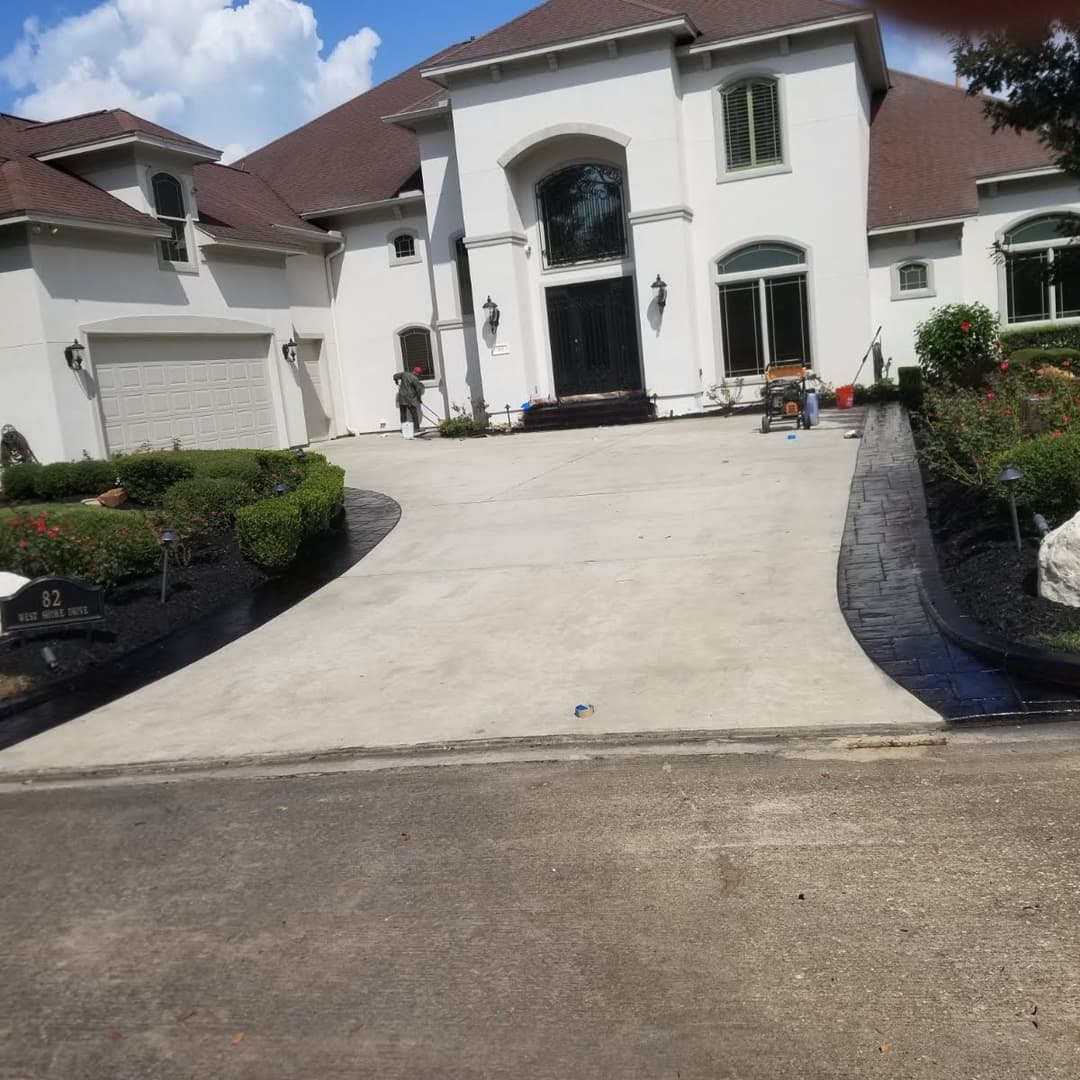 Modern white luxury home with landscaped front yard and driveway. Freshly maintained exterior.