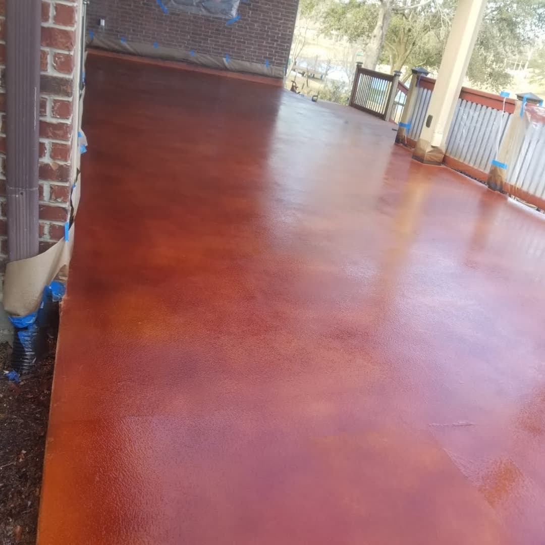 Stained concrete patio with a glossy finish and rustic tones, ready for outdoor use.