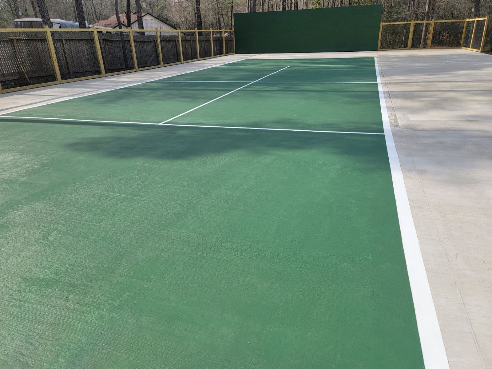 Vibrant Tennis Court with Green Stain image