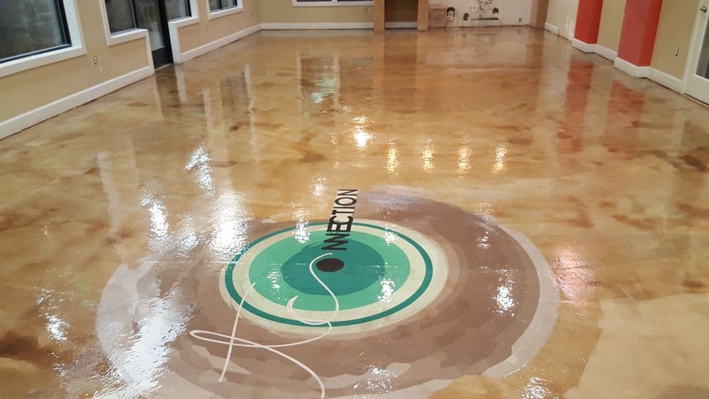 Polished decorative concrete floor with circular design featuring the word "Connection."