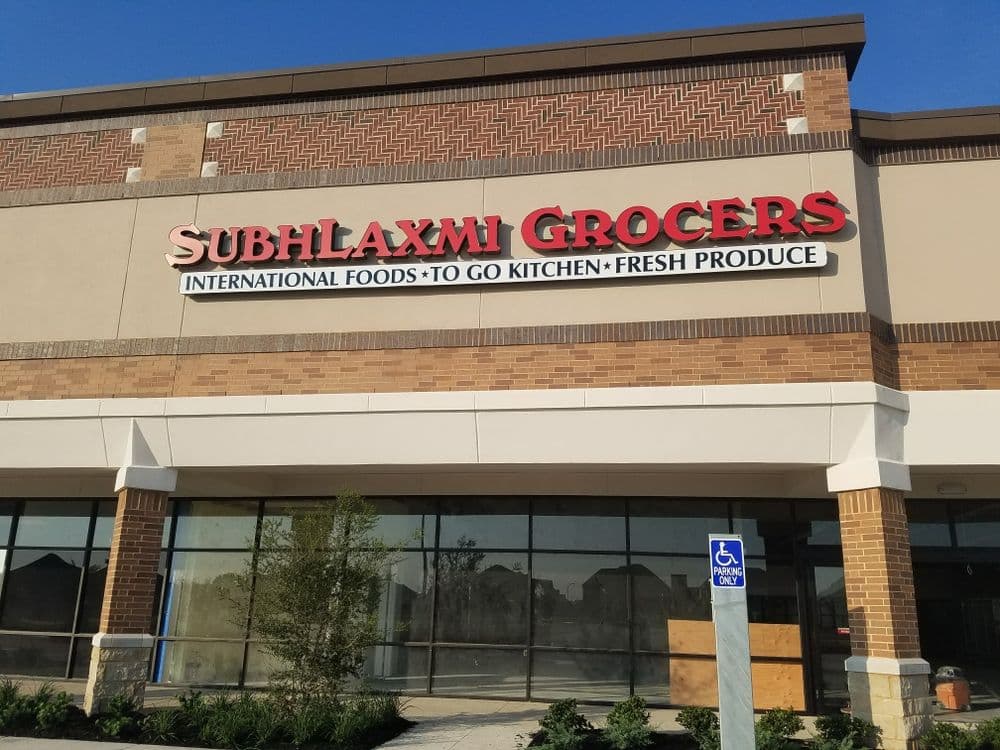 Subhlaxmi Grocers storefront featuring international foods, to-go kitchen, and fresh produce.