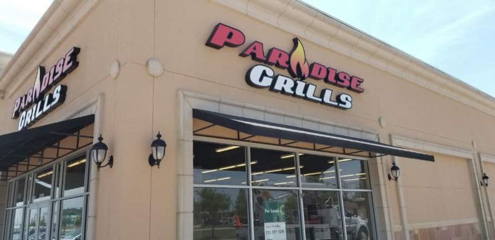 Paradise Grills storefront showcasing the brand name and outdoor signage.
